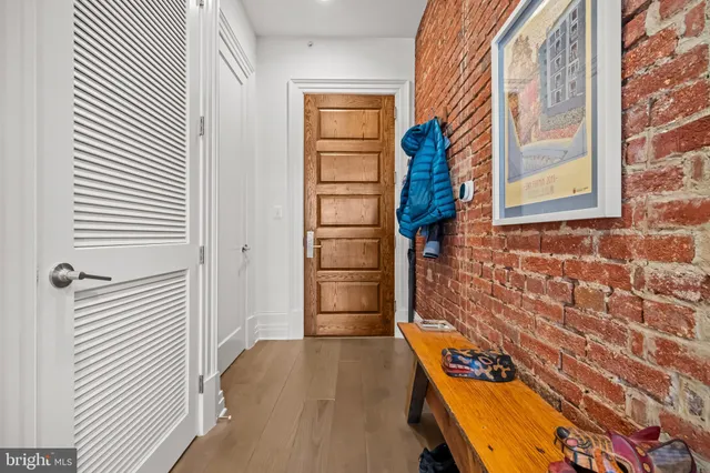 a view of a closet area with wooden floor