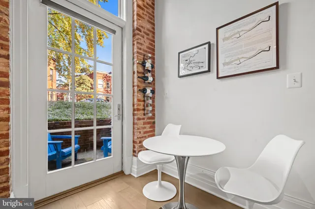 a bathroom with a toilet and a chair