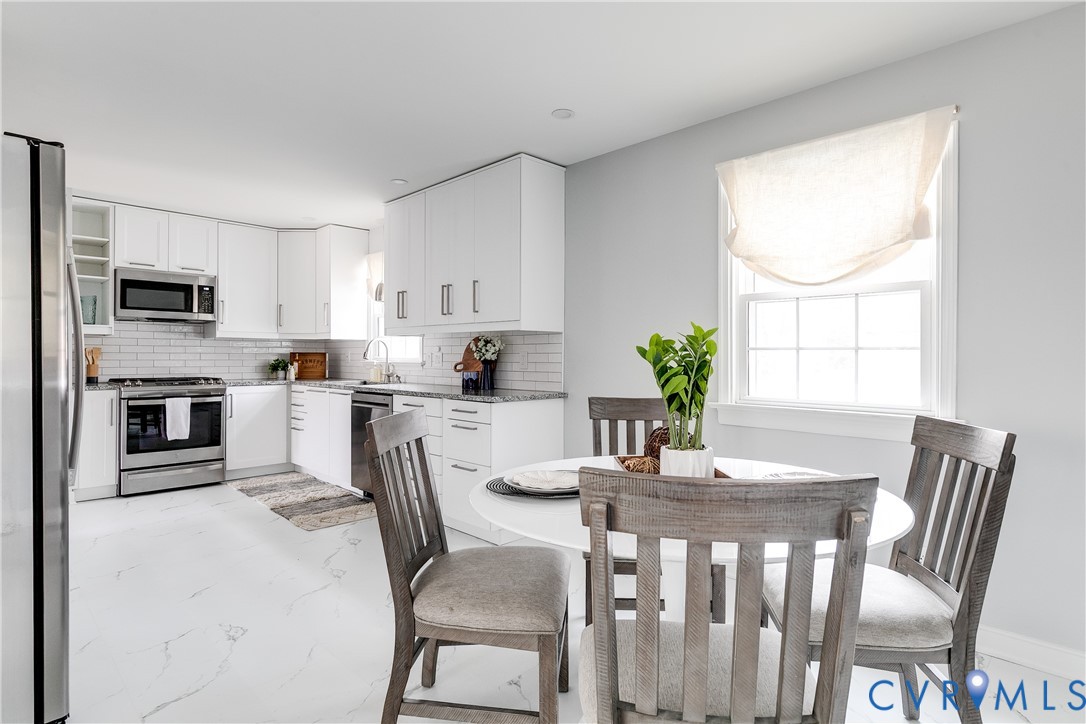 900 Ryder Road North Chesterfield, VA 23235 - Photo 15 of 45 a kitchen with a table chairs microwave and cabinets