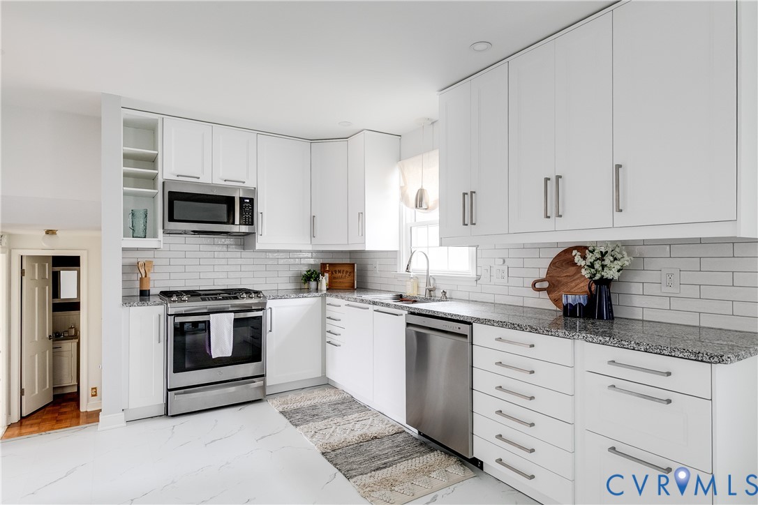 900 Ryder Road North Chesterfield, VA 23235 - Photo 9 of 45 a kitchen with granite countertop white cabinets and stainless steel appliances