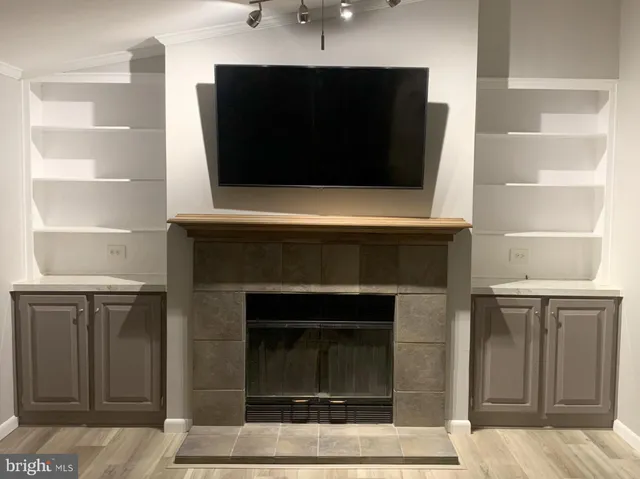 a living room with a fireplace and a flat screen tv