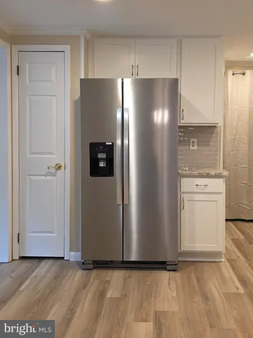 a view of a refrigerator in kitchen and a sink