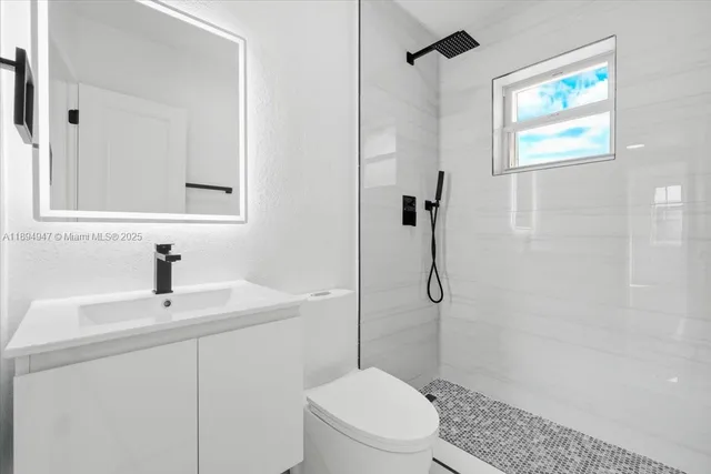 a bathroom with a sink toilet and shower