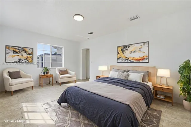 a bedroom with a bed and a couch