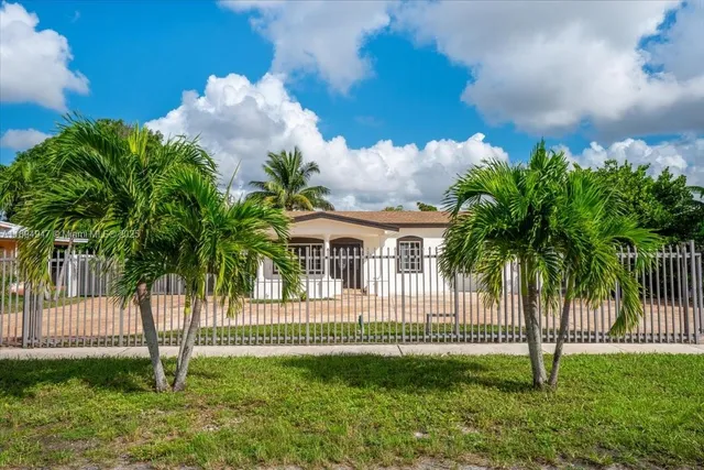 a view of a house with a yard and a garden