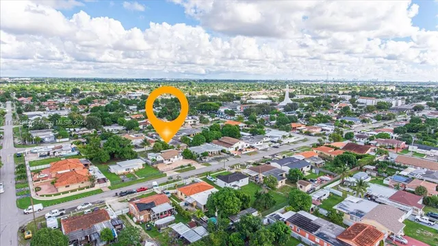 an aerial view of residential building with yard and swimming pool