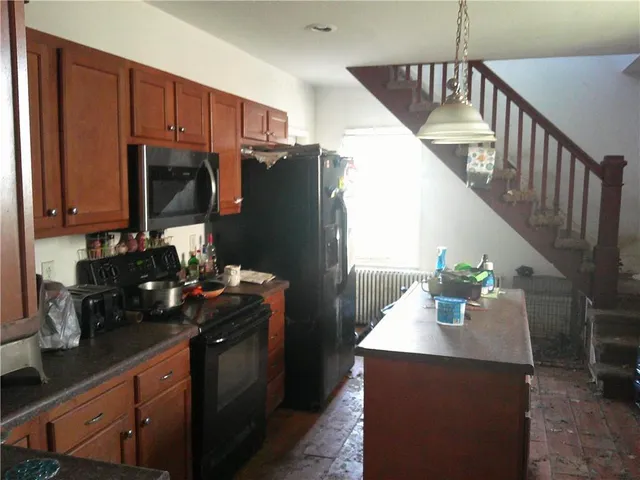 a kitchen with stainless steel appliances granite countertop a sink dishwasher stove and cabinets