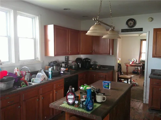 a living room with lots of different colored cloths