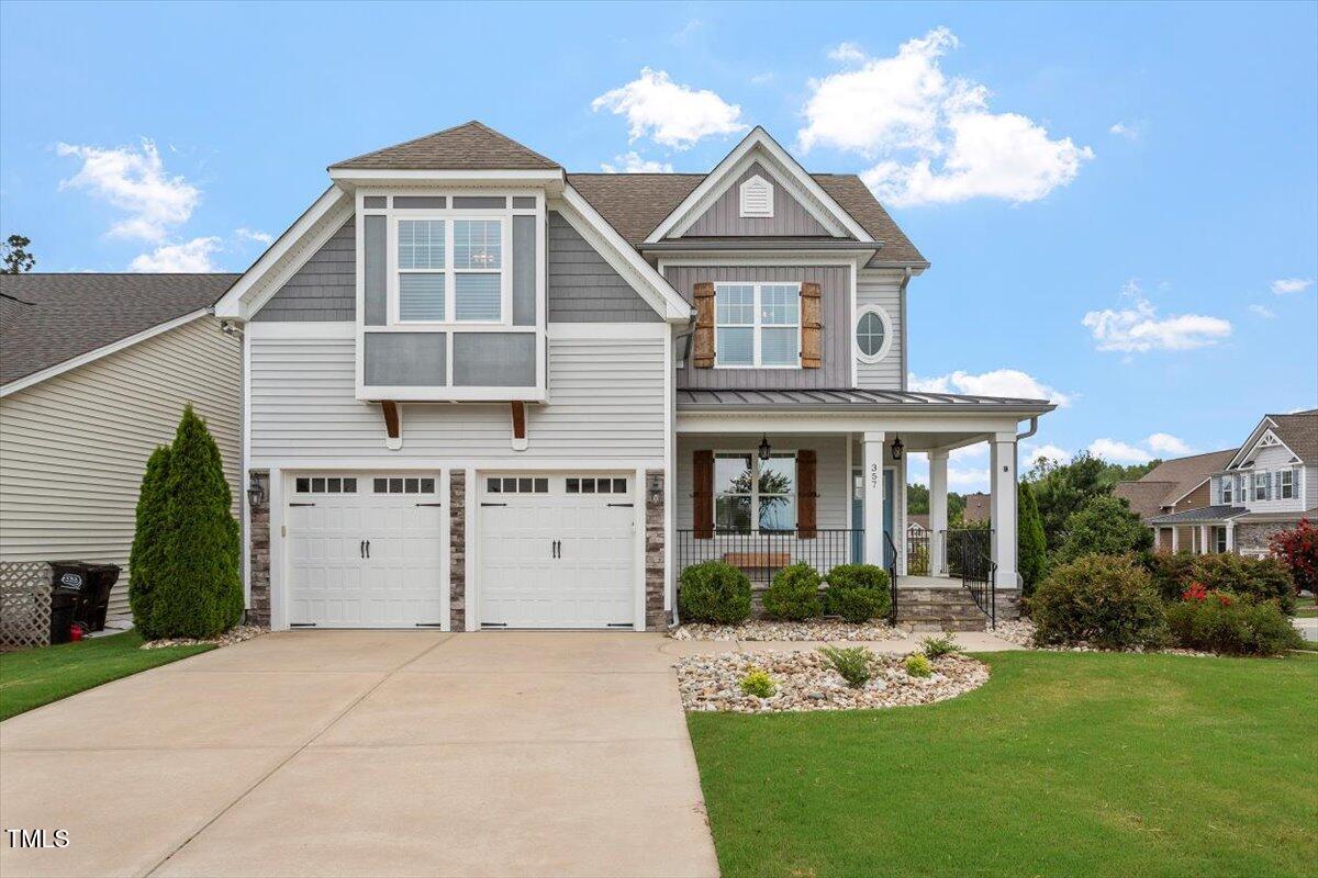 357 Marshcroft Way Rolesville, NC 27571 - Photo 1 of 41 a front view of a house with a garden and plants