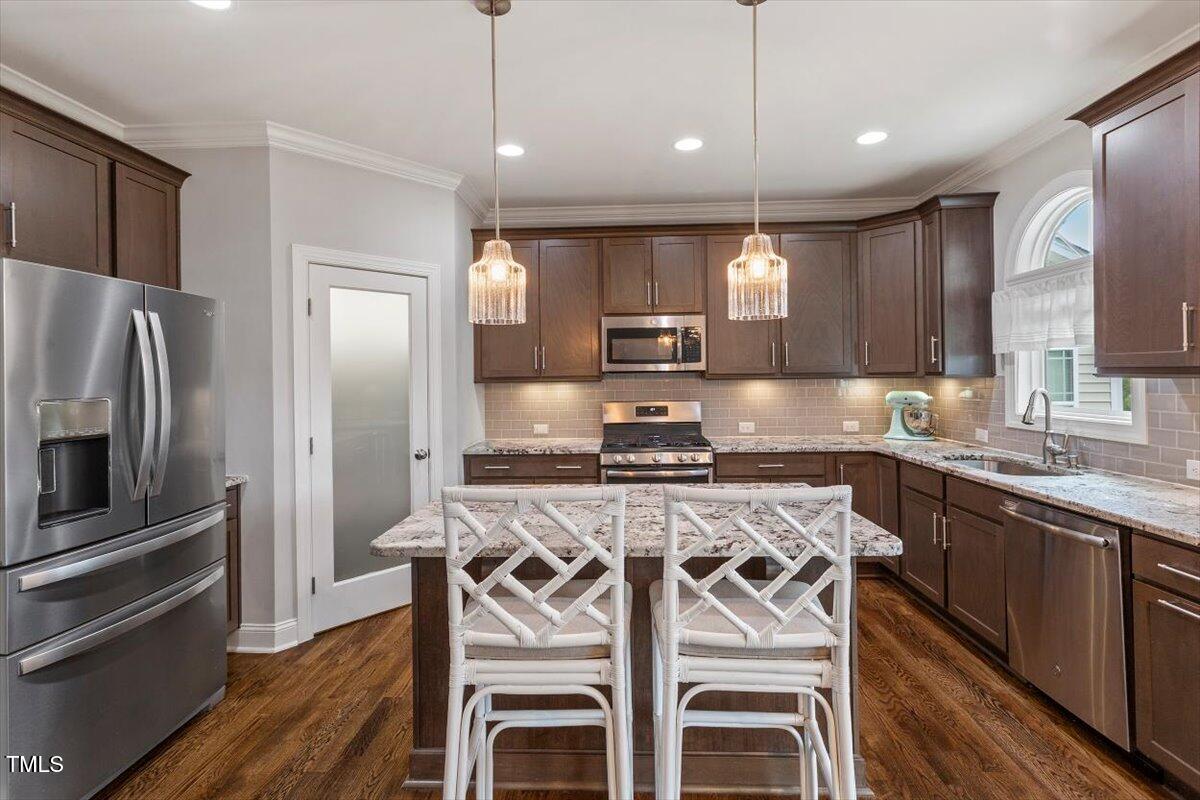357 Marshcroft Way Rolesville, NC 27571 - Photo 14 of 41 a kitchen with stainless steel appliances granite countertop a stove top oven a sink refrigerator and cabinets