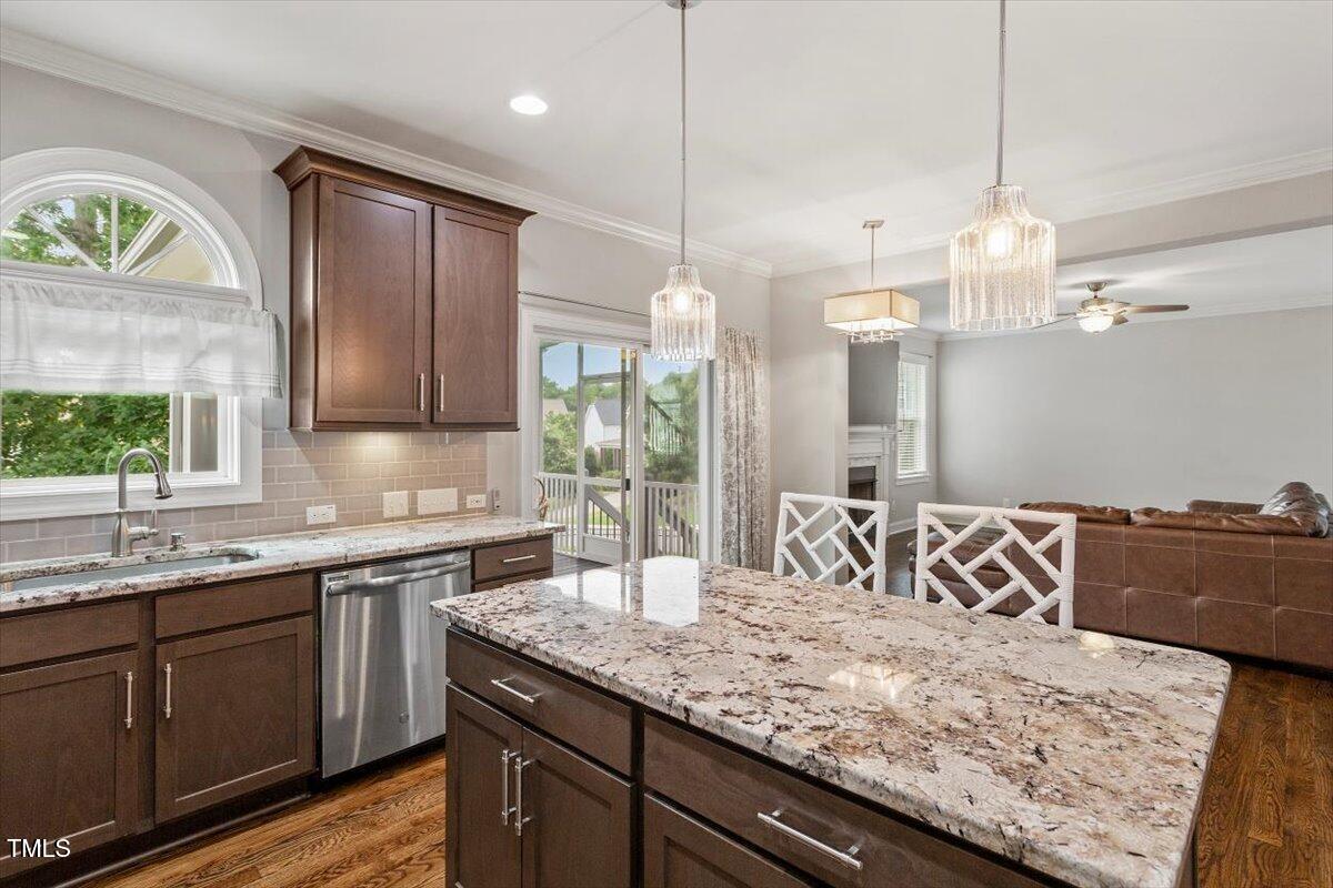 357 Marshcroft Way Rolesville, NC 27571 - Photo 15 of 41 a kitchen with a sink and a wooden floor