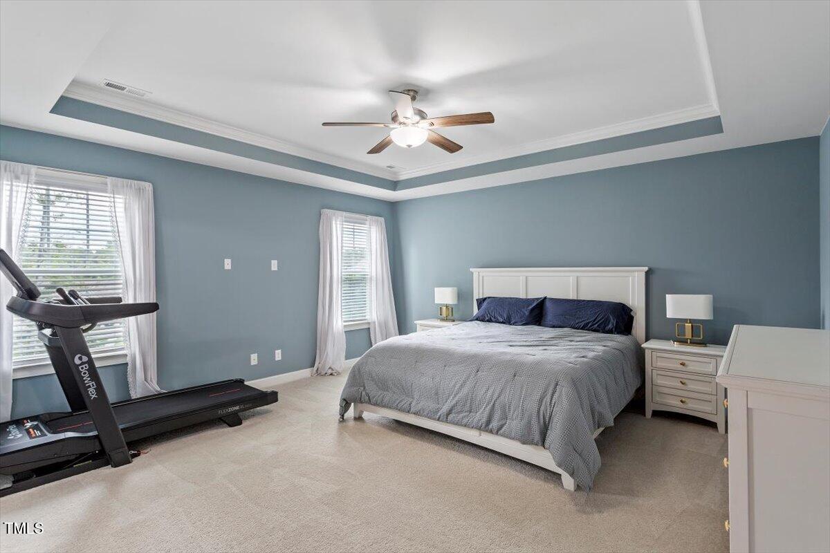 357 Marshcroft Way Rolesville, NC 27571 - Photo 19 of 41 a bedroom with a bed and a ceiling fan