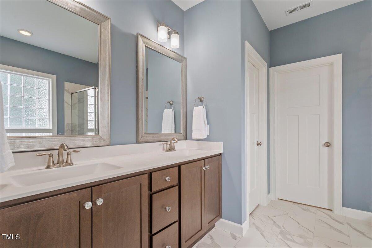357 Marshcroft Way Rolesville, NC 27571 - Photo 21 of 41 a bathroom with a sink and a mirror