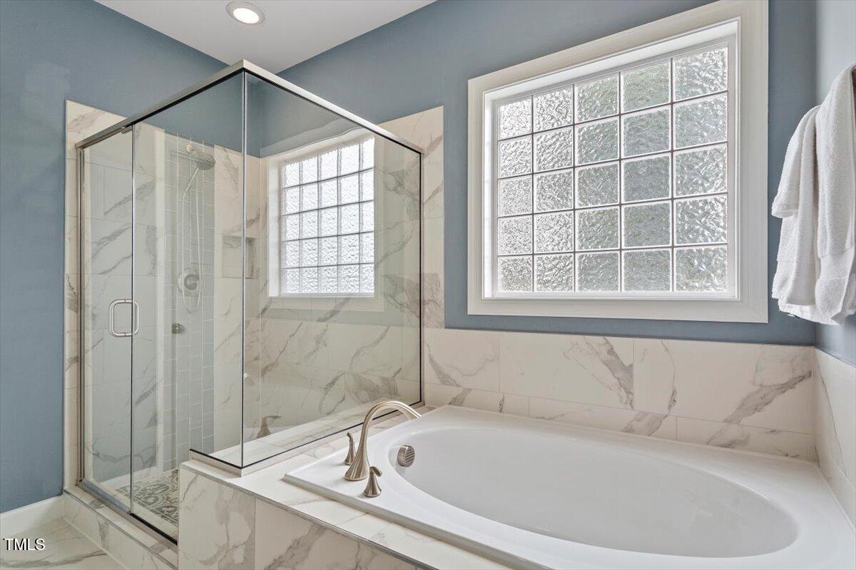 357 Marshcroft Way Rolesville, NC 27571 - Photo 22 of 41 a bathroom with a bathtub and a shower
