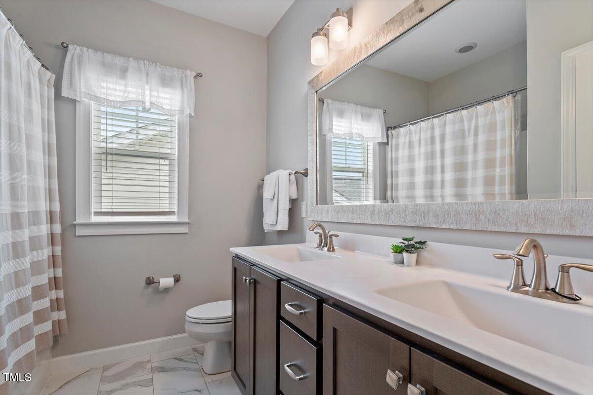 357 Marshcroft Way Rolesville, NC 27571 - Photo 25 of 41 a bathroom with a sink and a toilet