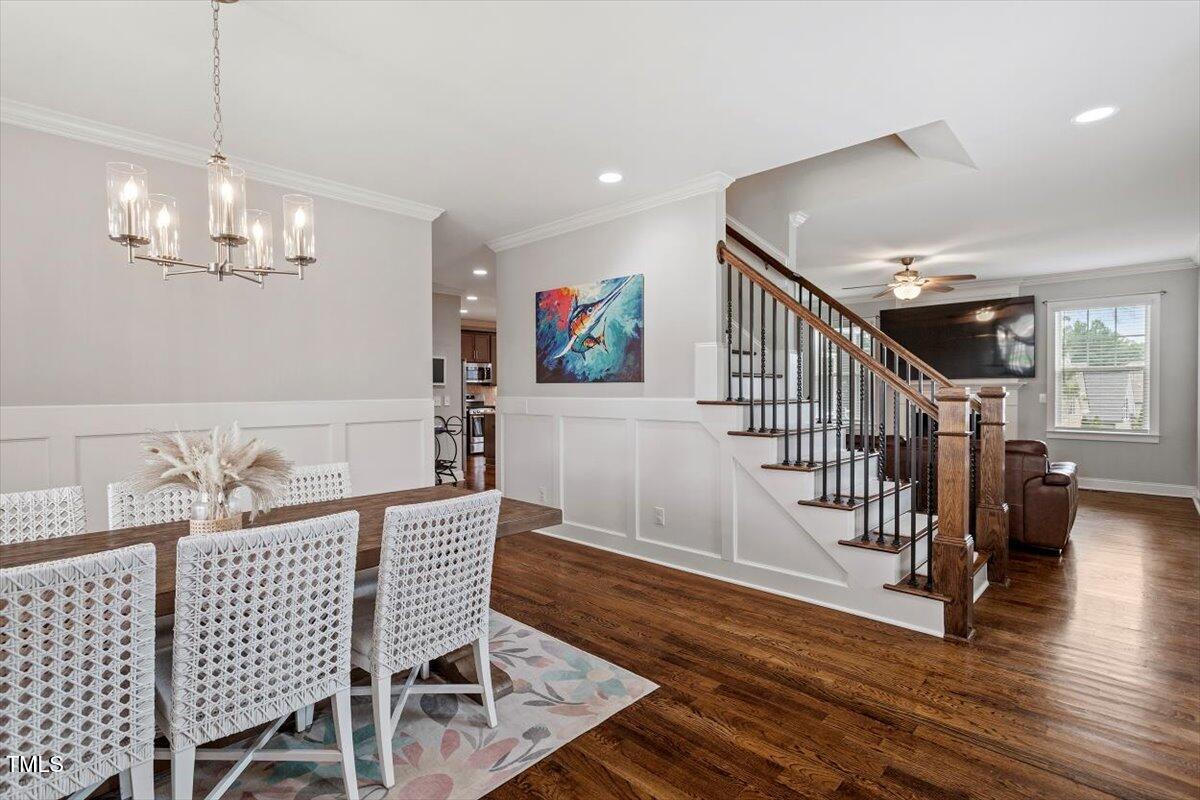 357 Marshcroft Way Rolesville, NC 27571 - Photo 5 of 41 a view of a dining room with furniture wooden floor and chandelier