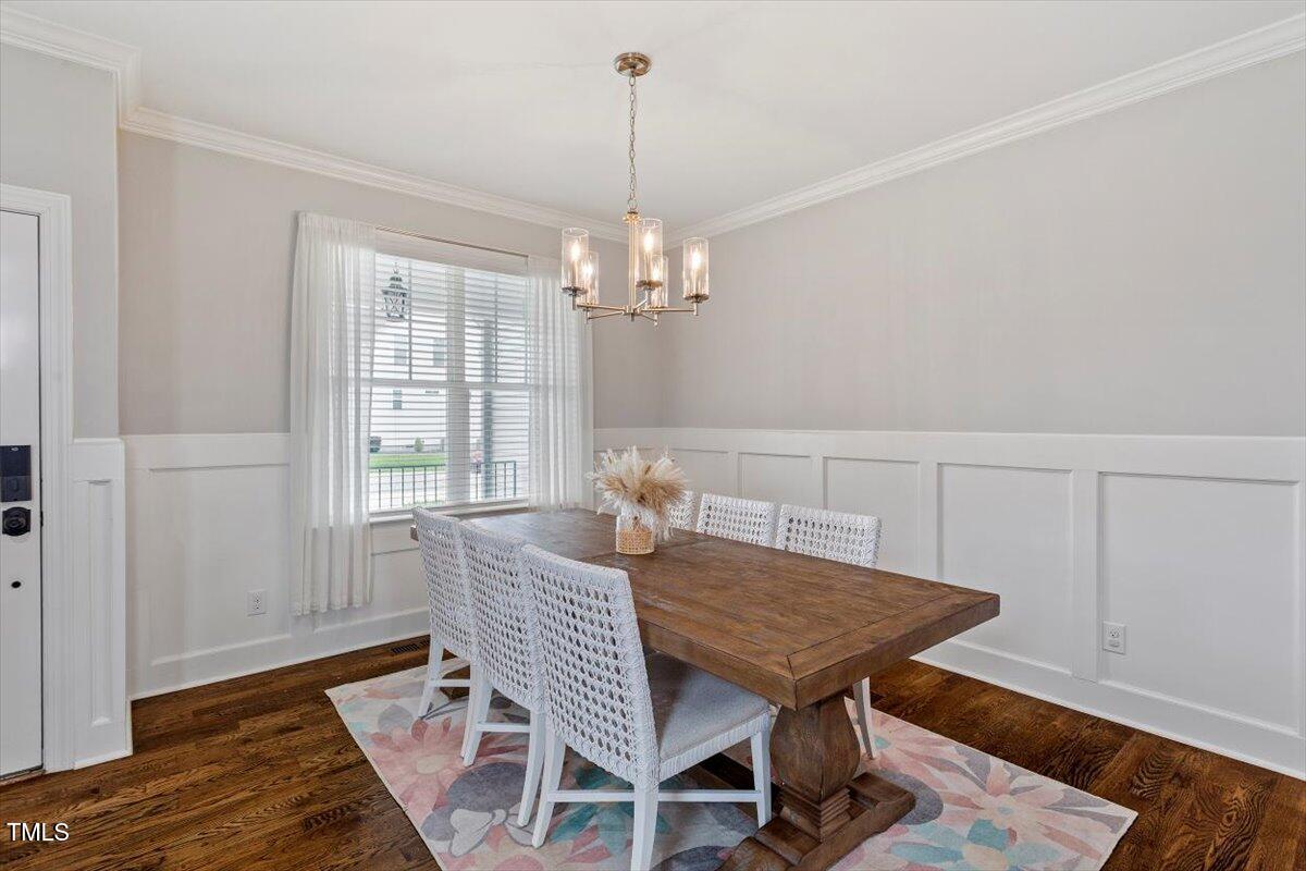 357 Marshcroft Way Rolesville, NC 27571 - Photo 6 of 41 a dining room with furniture a chandelier and wooden floor