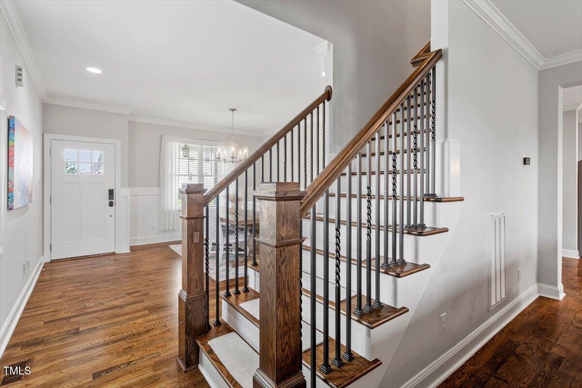 357 Marshcroft Way Rolesville, NC 27571 - Photo 7 of 41 a view of staircase with wooden floor and white walls
