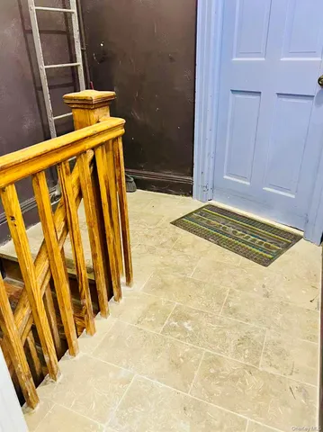 an empty room with wooden floor and a window