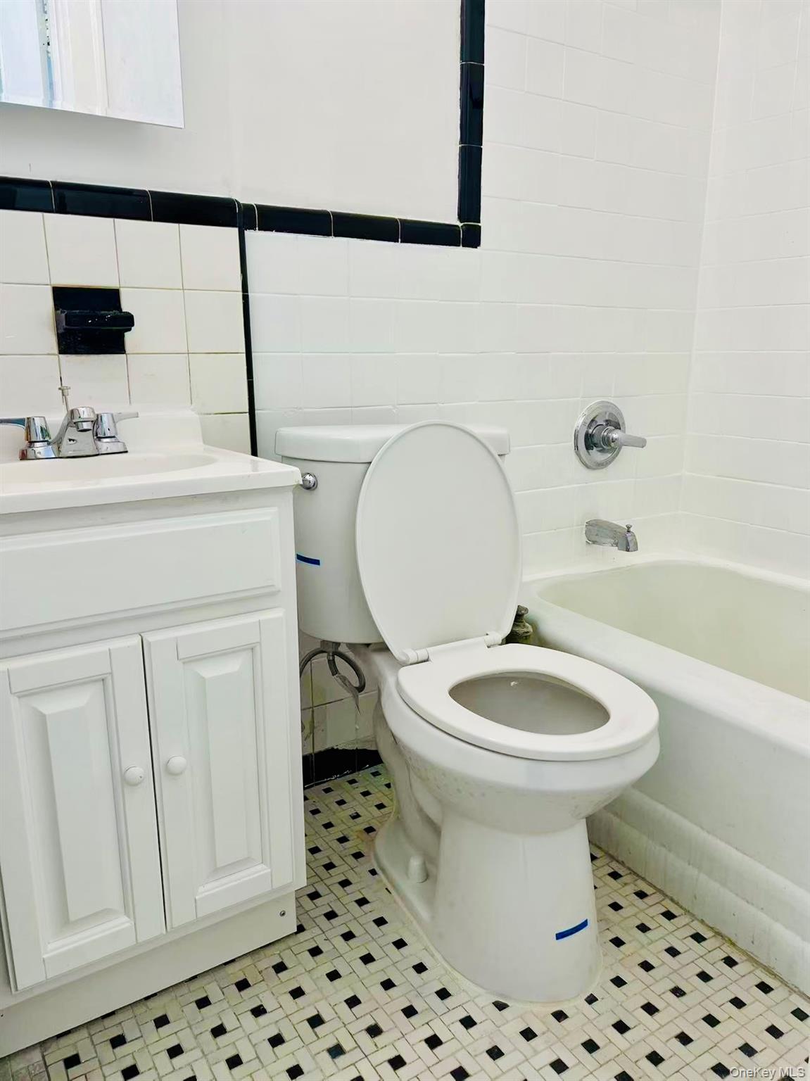 35-40 92nd Street, Unit 2FL FRONT Queens, NY 11372 - Photo 6 of 6 a bathroom with a sink a toilet and a mirror