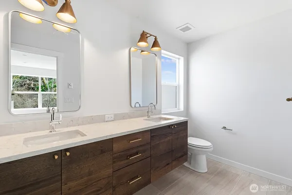 a bathroom with a toilet sink and mirror