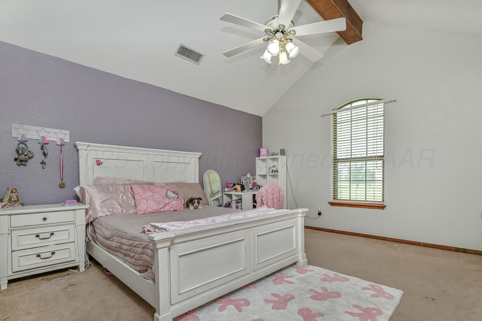 9151 Helium Road Amarillo, TX 79119 - Photo 12 of 49 a bedroom with a bed and a window