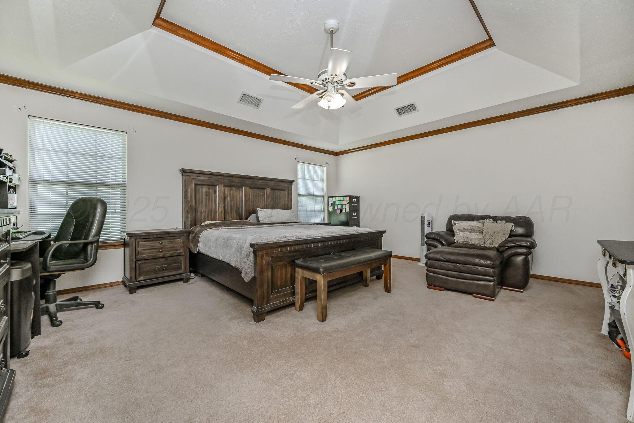 9151 Helium Road Amarillo, TX 79119 - Photo 16 of 49 a bedroom with furniture and a chandelier