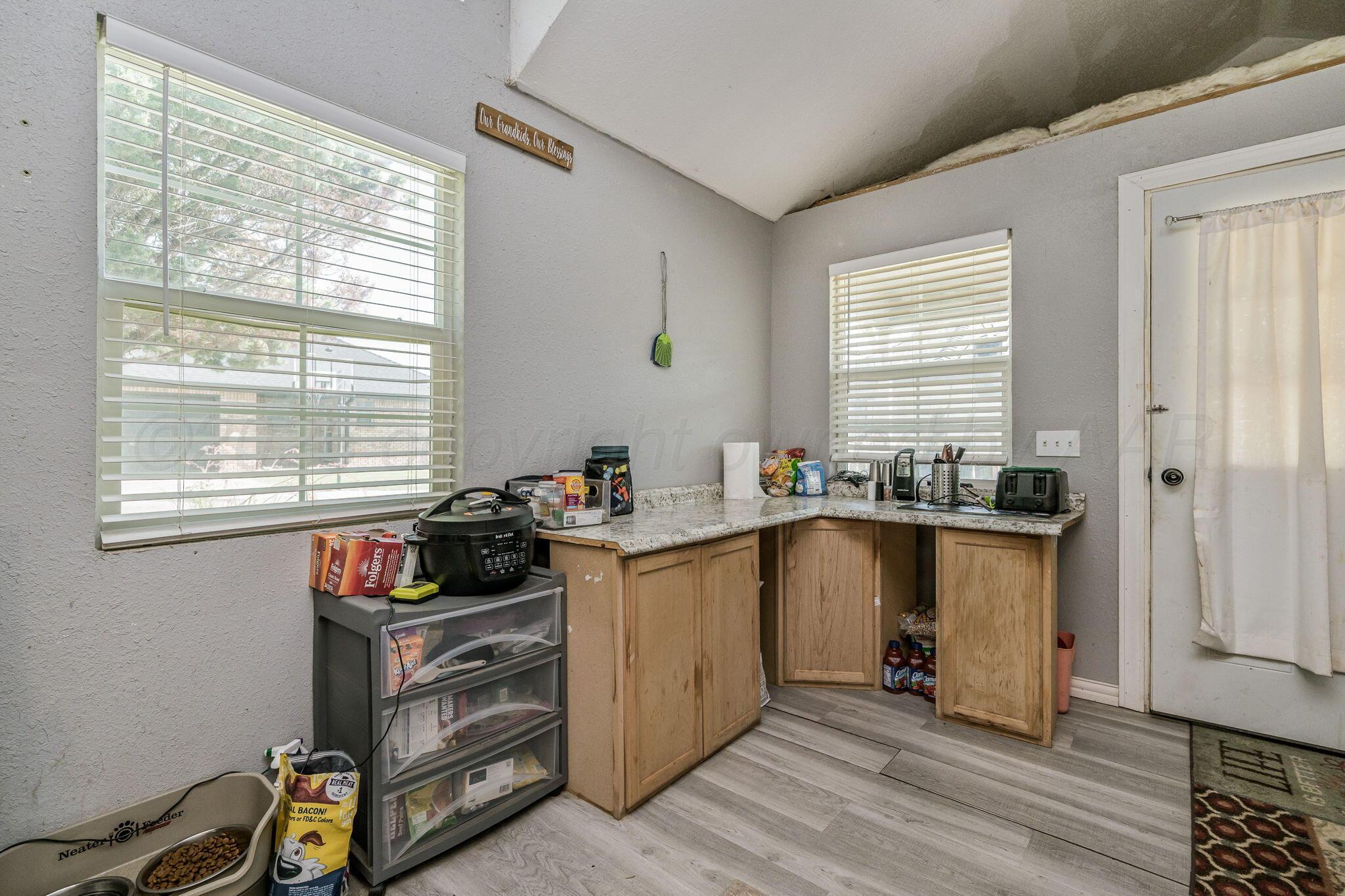9151 Helium Road Amarillo, TX 79119 - Photo 22 of 49 a kitchen with granite countertop a stove and a window