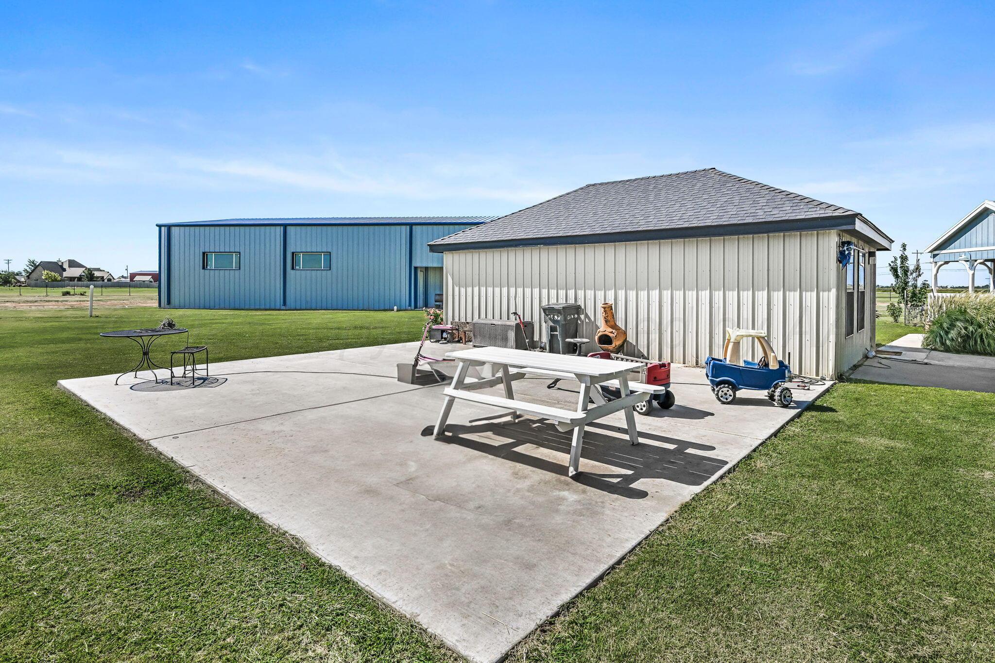 9151 Helium Road Amarillo, TX 79119 - Photo 25 of 49 a backyard of a house with table and chairs