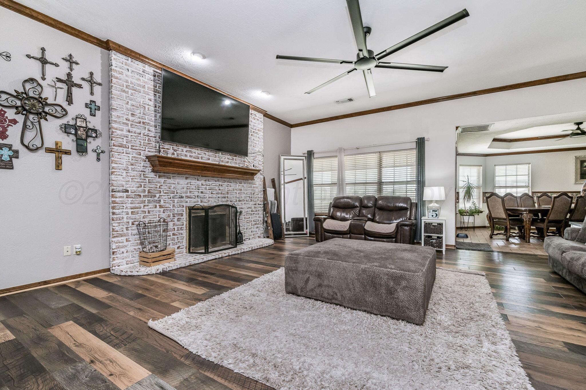 9151 Helium Road Amarillo, TX 79119 - Photo 3 of 49 a living room with furniture fireplace and flat screen tv