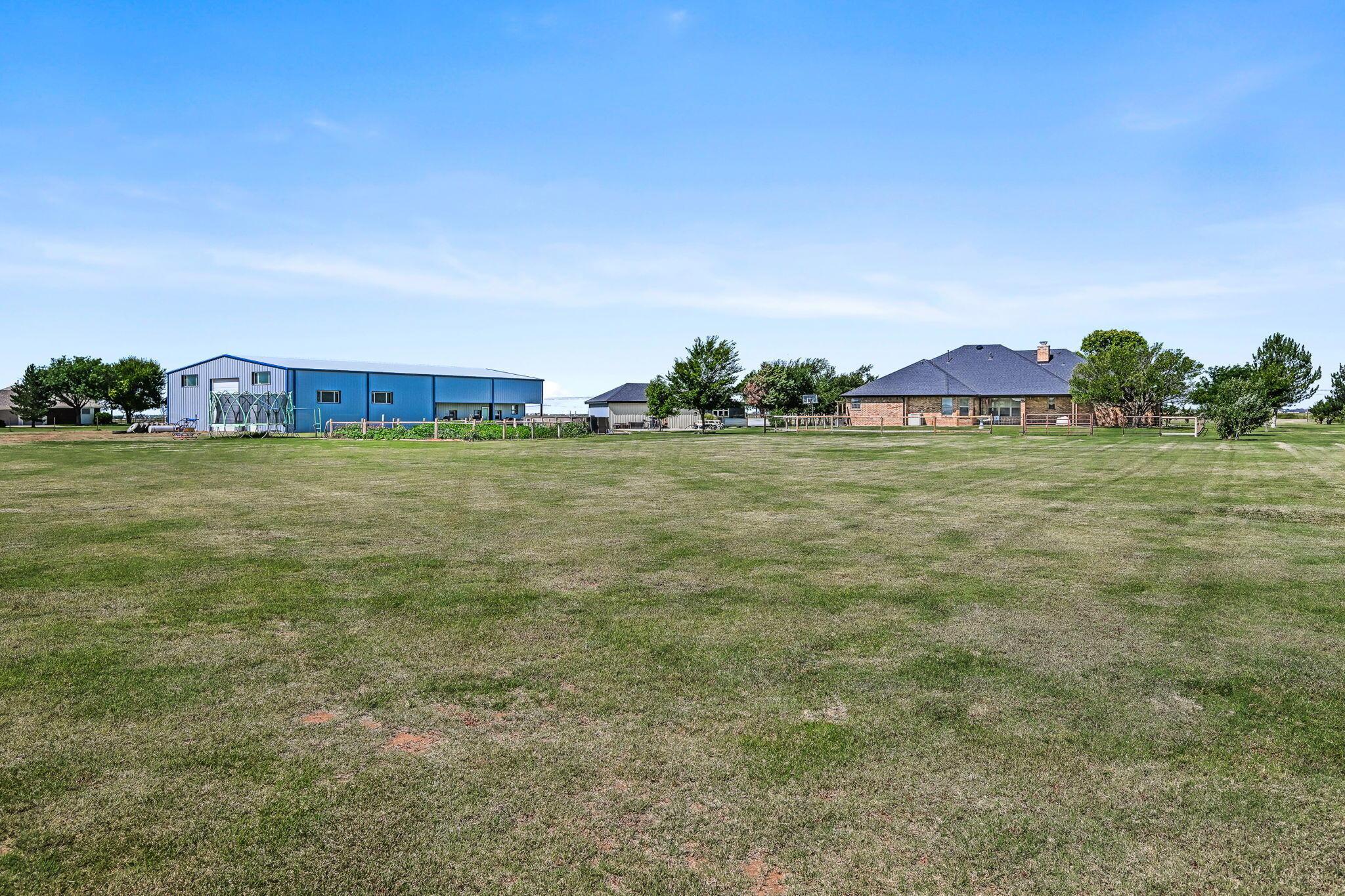 9151 Helium Road Amarillo, TX 79119 - Photo 35 of 49 a view of a big yard with a large trees
