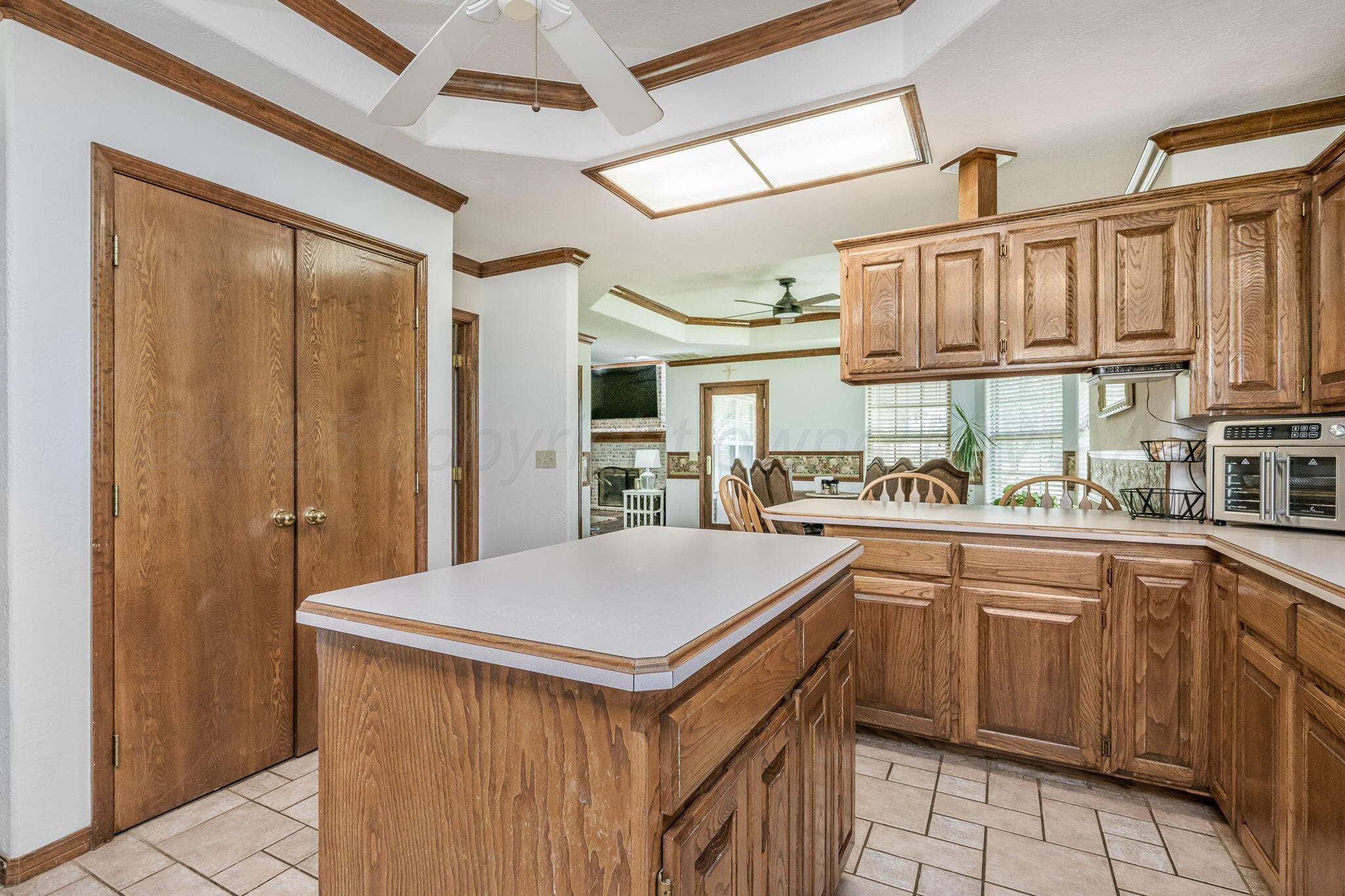 9151 Helium Road Amarillo, TX 79119 - Photo 9 of 49 a kitchen with granite countertop a sink stainless steel appliances and cabinets