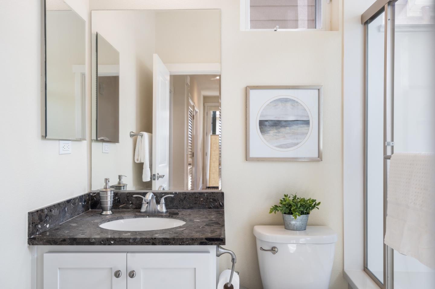 100 Tilton Avenue San Mateo, CA 94401 - Photo 11 of 23 a bathroom with a granite countertop sink and a mirror with toilet