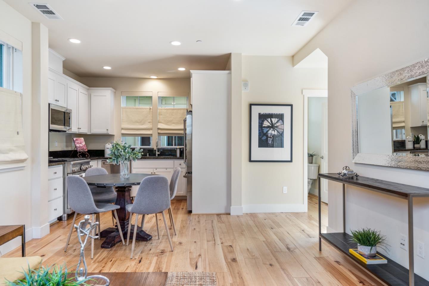 100 Tilton Avenue San Mateo, CA 94401 - Photo 5 of 23 a kitchen with stainless steel appliances kitchen island granite countertop a refrigerator and a dining table
