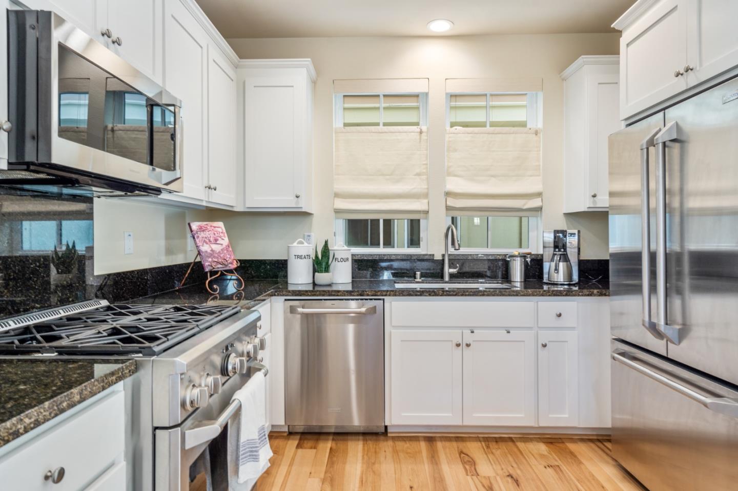 100 Tilton Avenue San Mateo, CA 94401 - Photo 6 of 23 a kitchen with stainless steel appliances granite countertop a stove and a sink