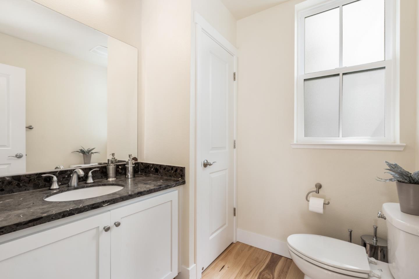 100 Tilton Avenue San Mateo, CA 94401 - Photo 7 of 23 a bathroom with a granite countertop sink and a mirror