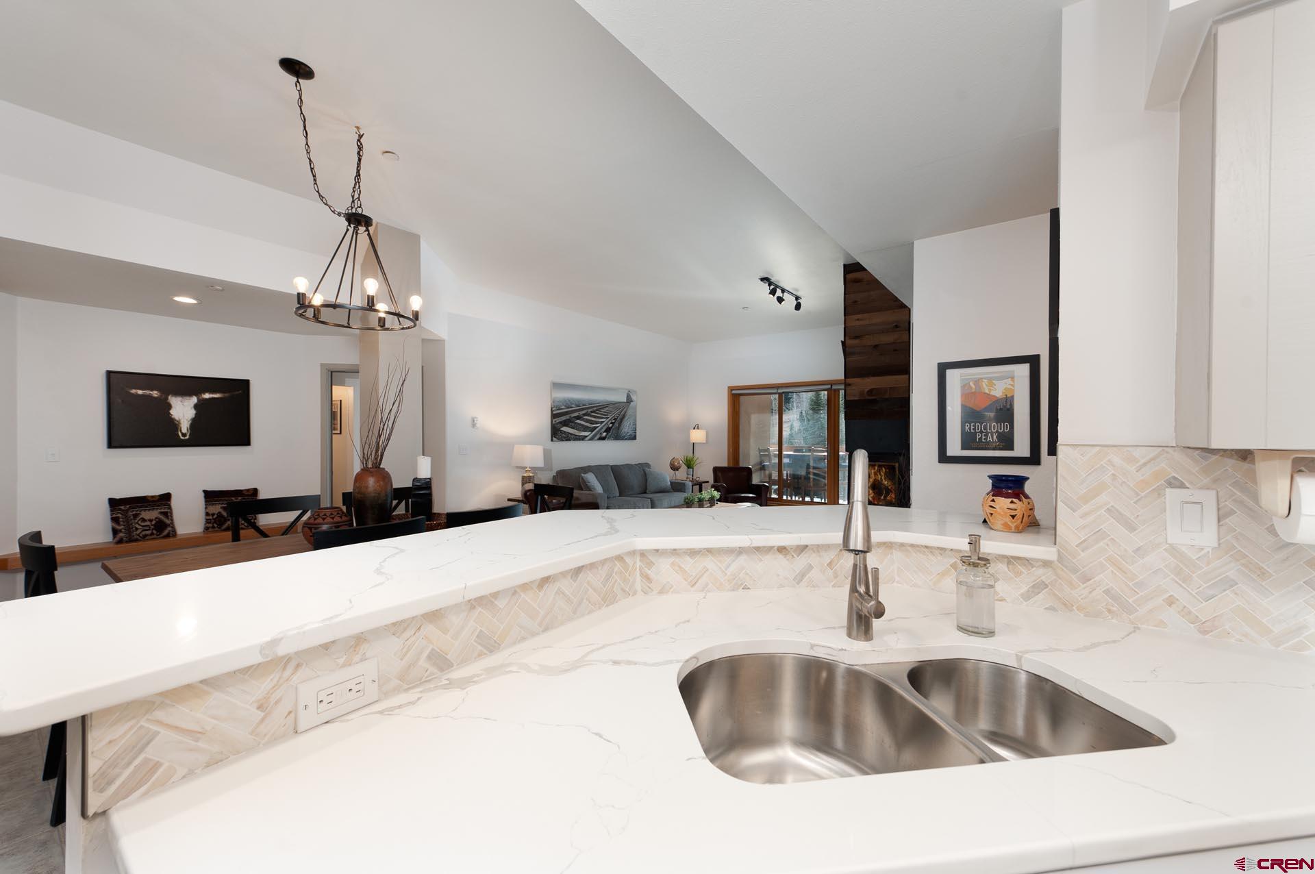 93 Needles Way, Unit 501 Durango, CO 81301 - Photo 12 of 32 a kitchen with sink refrigerator and microwave