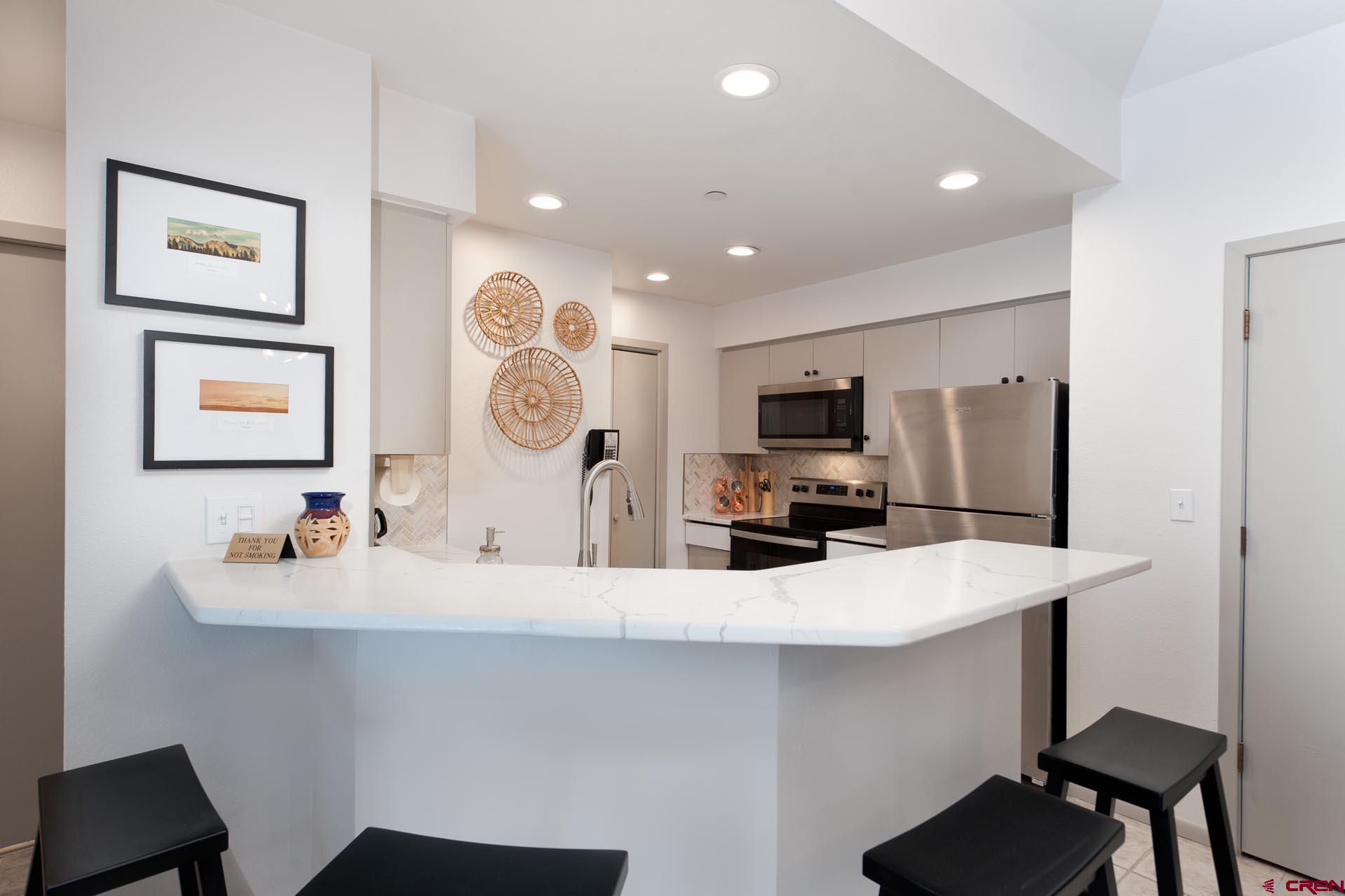93 Needles Way, Unit 501 Durango, CO 81301 - Photo 13 of 32 a kitchen with a sink and a refrigerator
