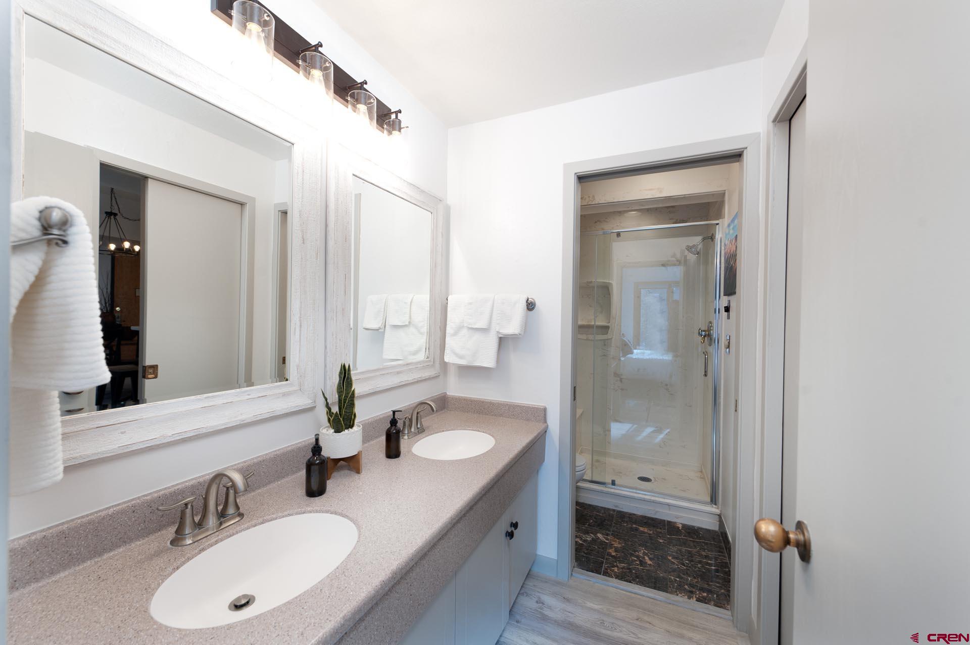 93 Needles Way, Unit 501 Durango, CO 81301 - Photo 18 of 32 a bathroom with a sink double vanity granite tub and shower