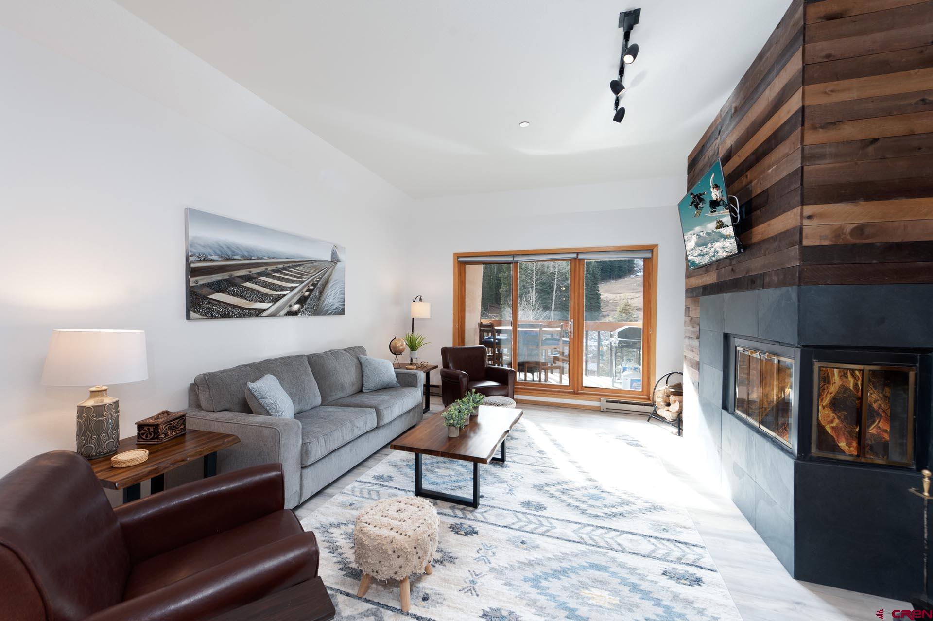 93 Needles Way, Unit 501 Durango, CO 81301 - Photo 3 of 32 a living room with furniture and a fireplace