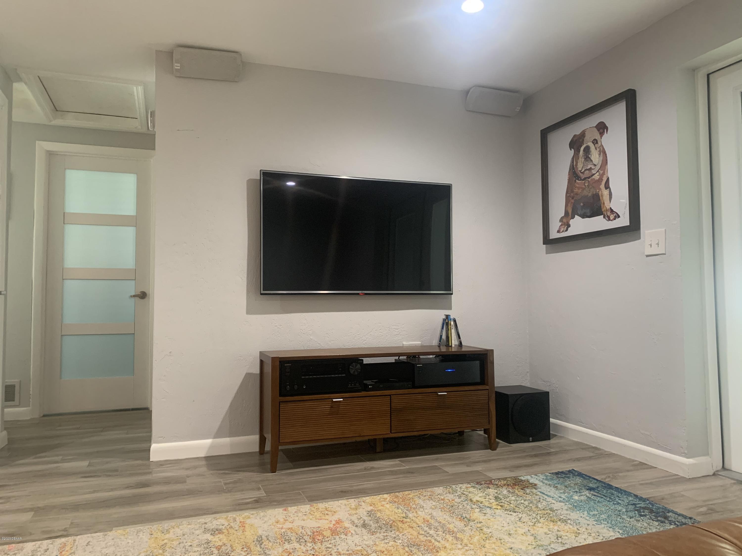 109 Floridana Road DeBary, FL 32713 - Photo 14 of 38 a living room with a couch and a flat screen tv