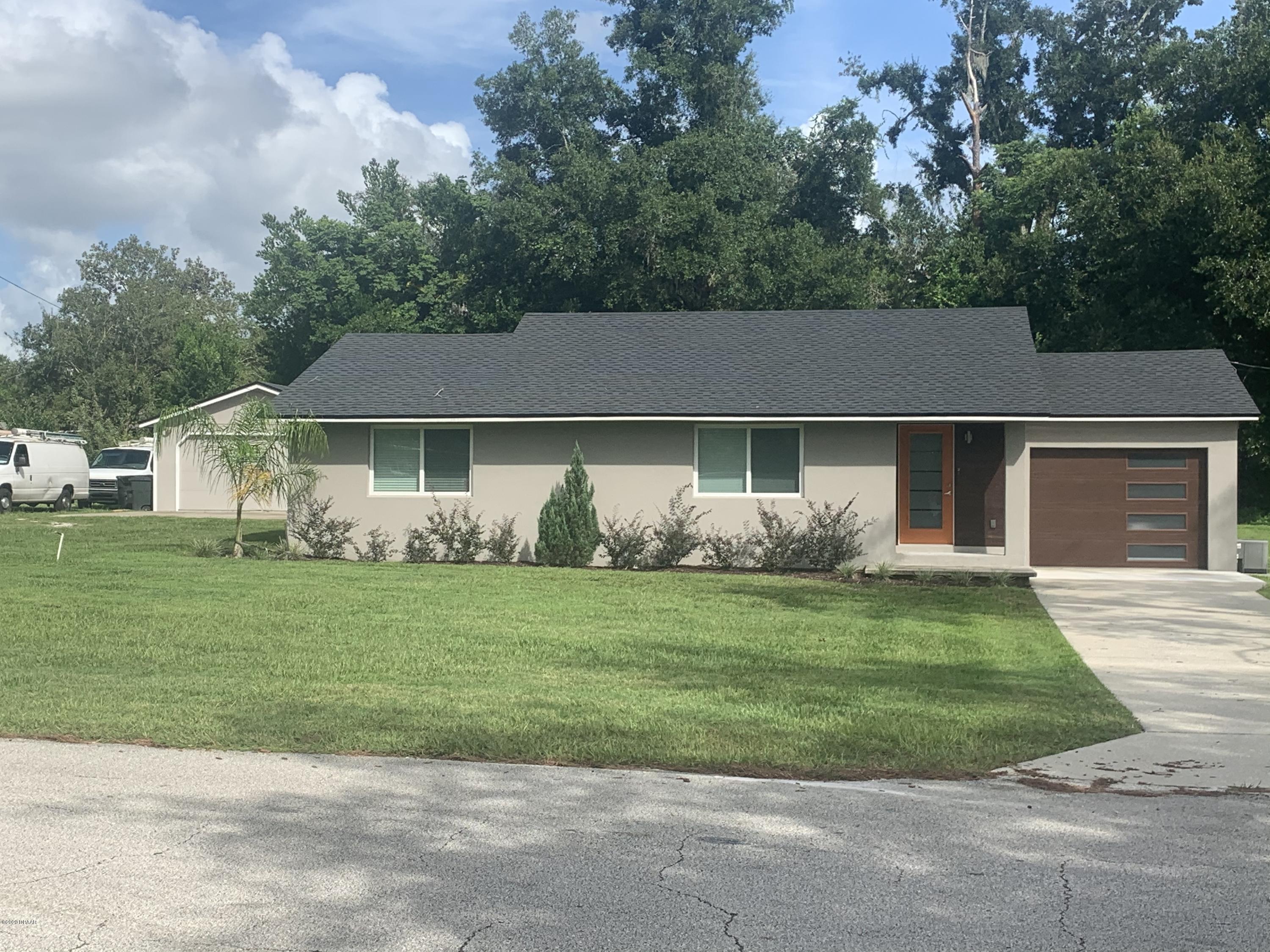 109 Floridana Road DeBary, FL 32713 - Photo 2 of 38 a front view of a house with a garden