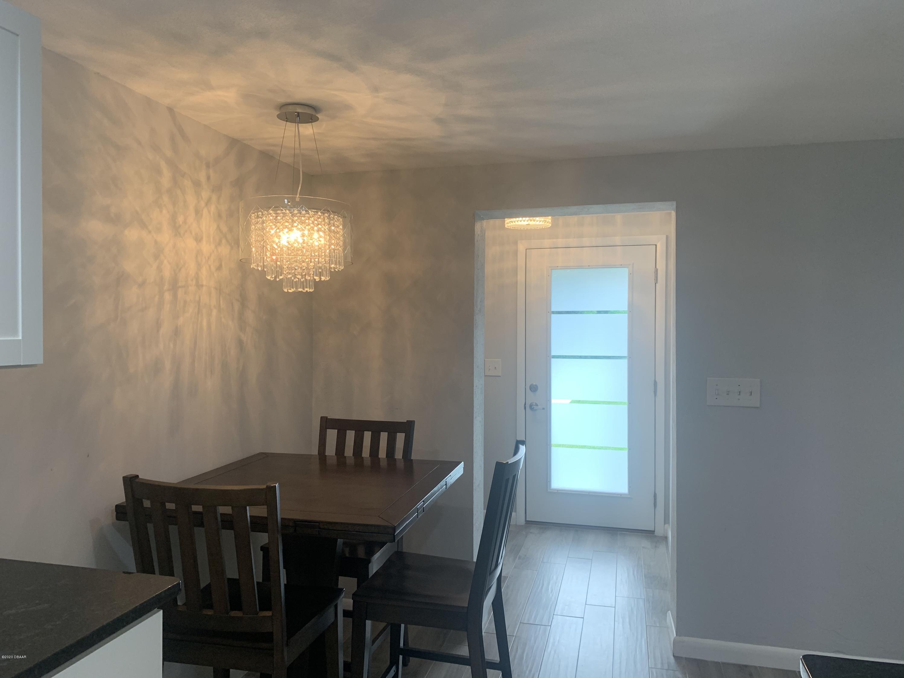 109 Floridana Road DeBary, FL 32713 - Photo 22 of 38 a view of a dining room with furniture and wooden floor