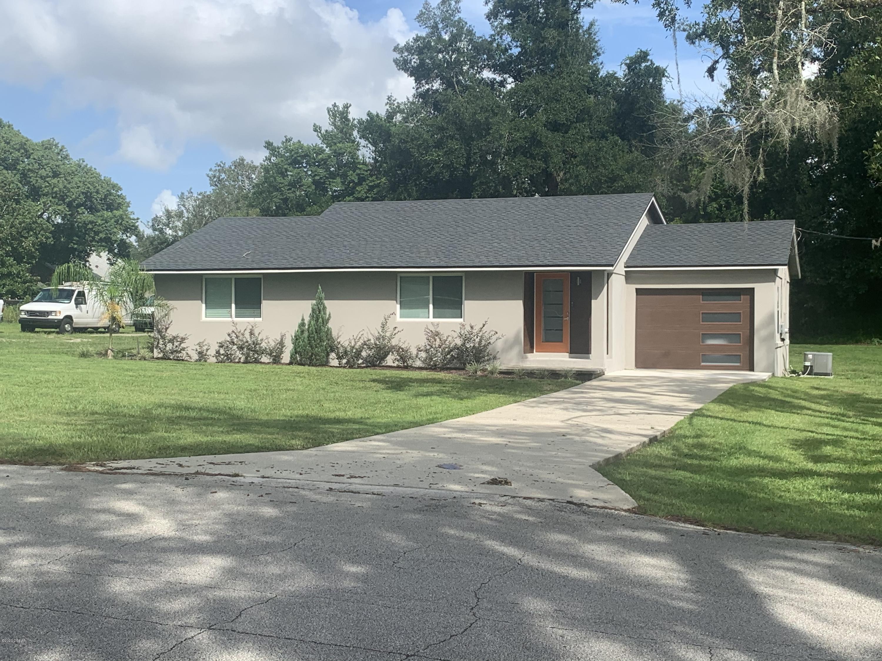 109 Floridana Road DeBary, FL 32713 - Photo 4 of 38 a front view of a house with garden