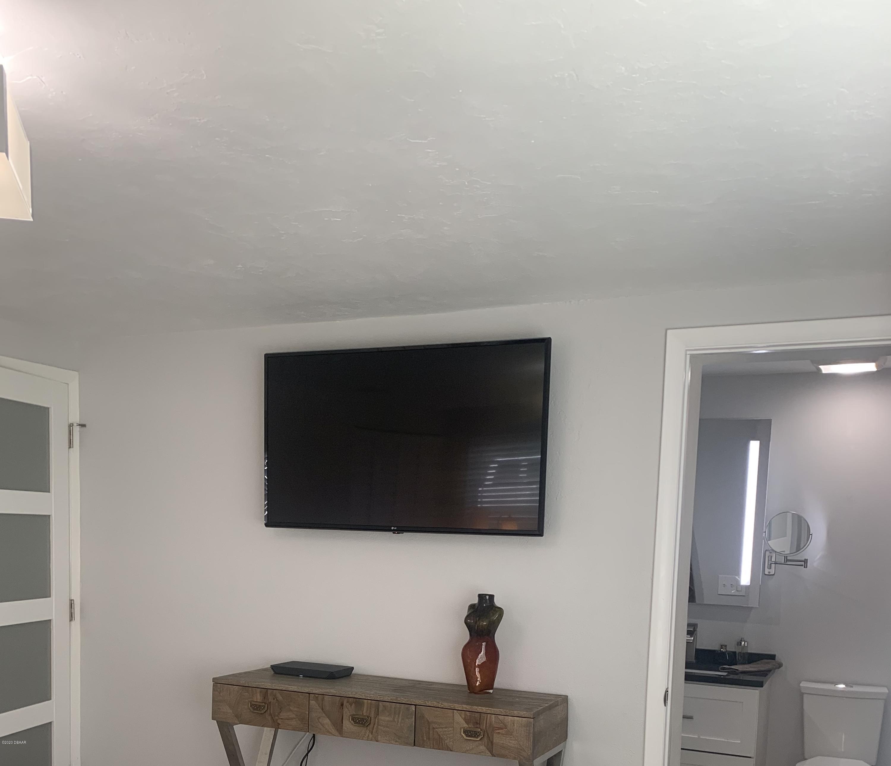 109 Floridana Road DeBary, FL 32713 - Photo 6 of 38 a living room with a flat screen tv and a fireplace