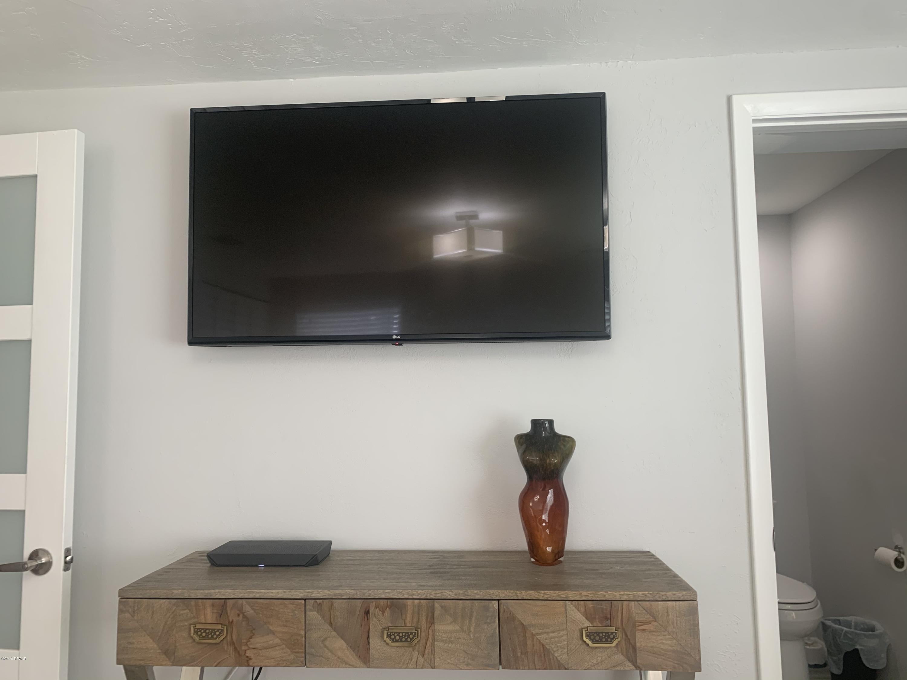109 Floridana Road DeBary, FL 32713 - Photo 7 of 38 a living room with a flat screen tv and a fireplace