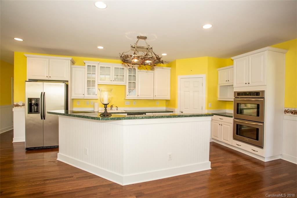 122 Barrier Farms Road Midland, NC 28107 - Photo 11 of 33 a kitchen with stainless steel appliances granite countertop a sink refrigerator and cabinets
