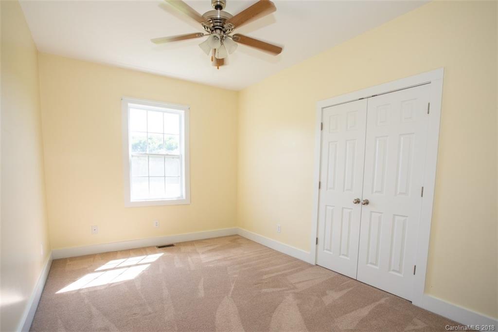 122 Barrier Farms Road Midland, NC 28107 - Photo 13 of 33 an empty room with windows and fan