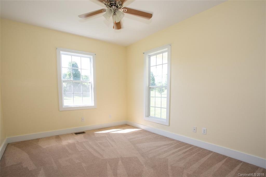 122 Barrier Farms Road Midland, NC 28107 - Photo 16 of 33 an empty room with a window and a fan