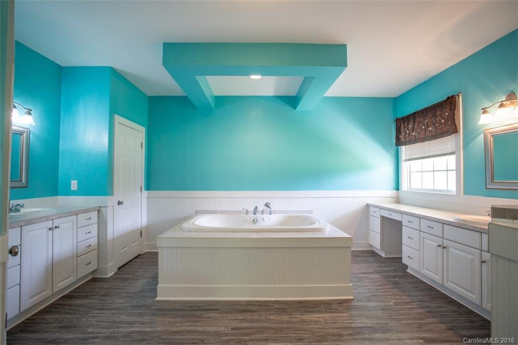 122 Barrier Farms Road Midland, NC 28107 - Photo 22 of 33 a bathroom with a sink and a large mirror